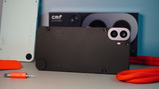 The CMF Phone 1 surrounded by some of the accessories for the phone