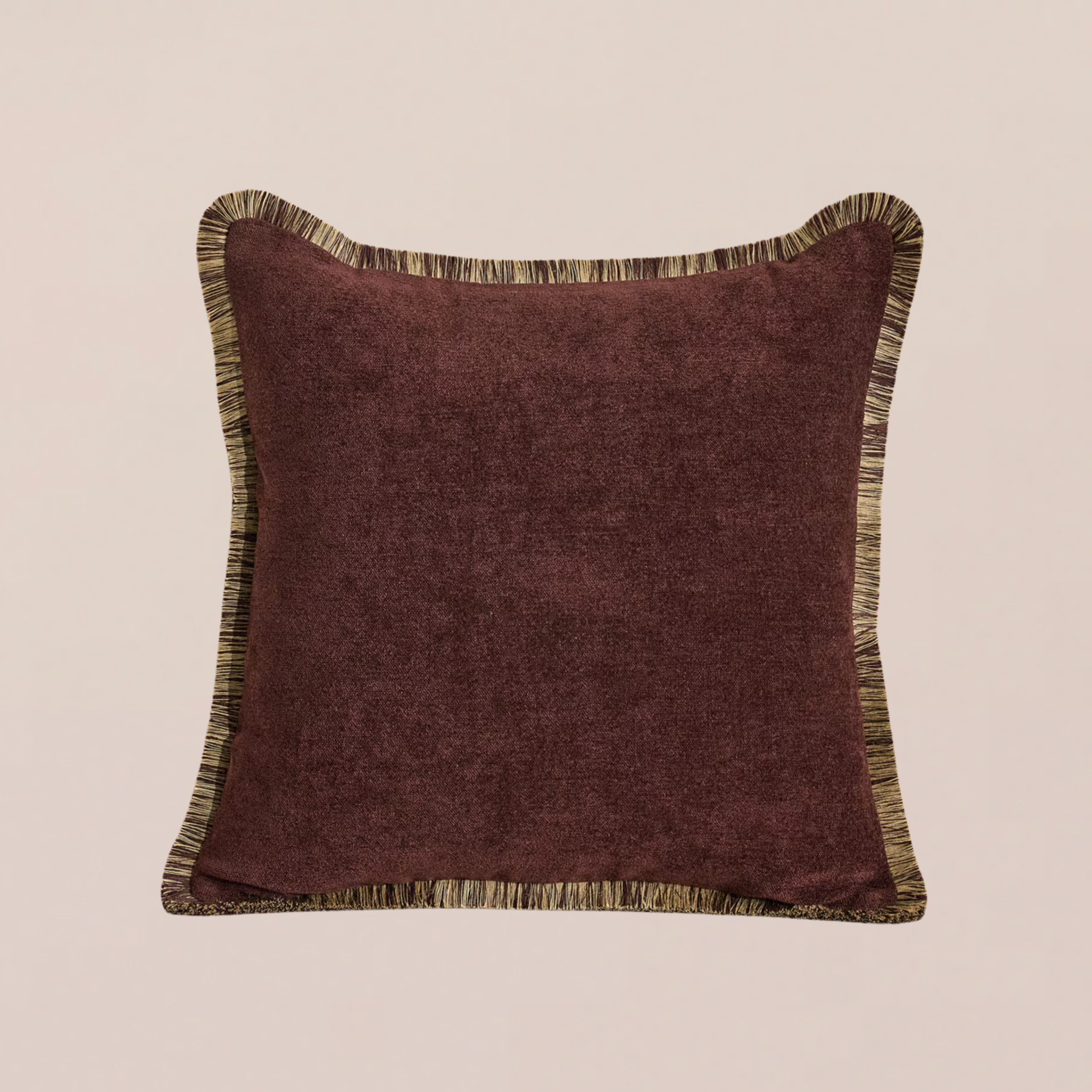 A burgundy cushion with fringing 