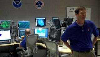 Daniel Brown, the Warning Coordination Meteorologist, inside the NHC's main room.