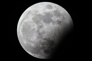 The full "Hunter's moon" is pictured during a partial lunar eclipse above Kuwait City on October 28, 2023. 