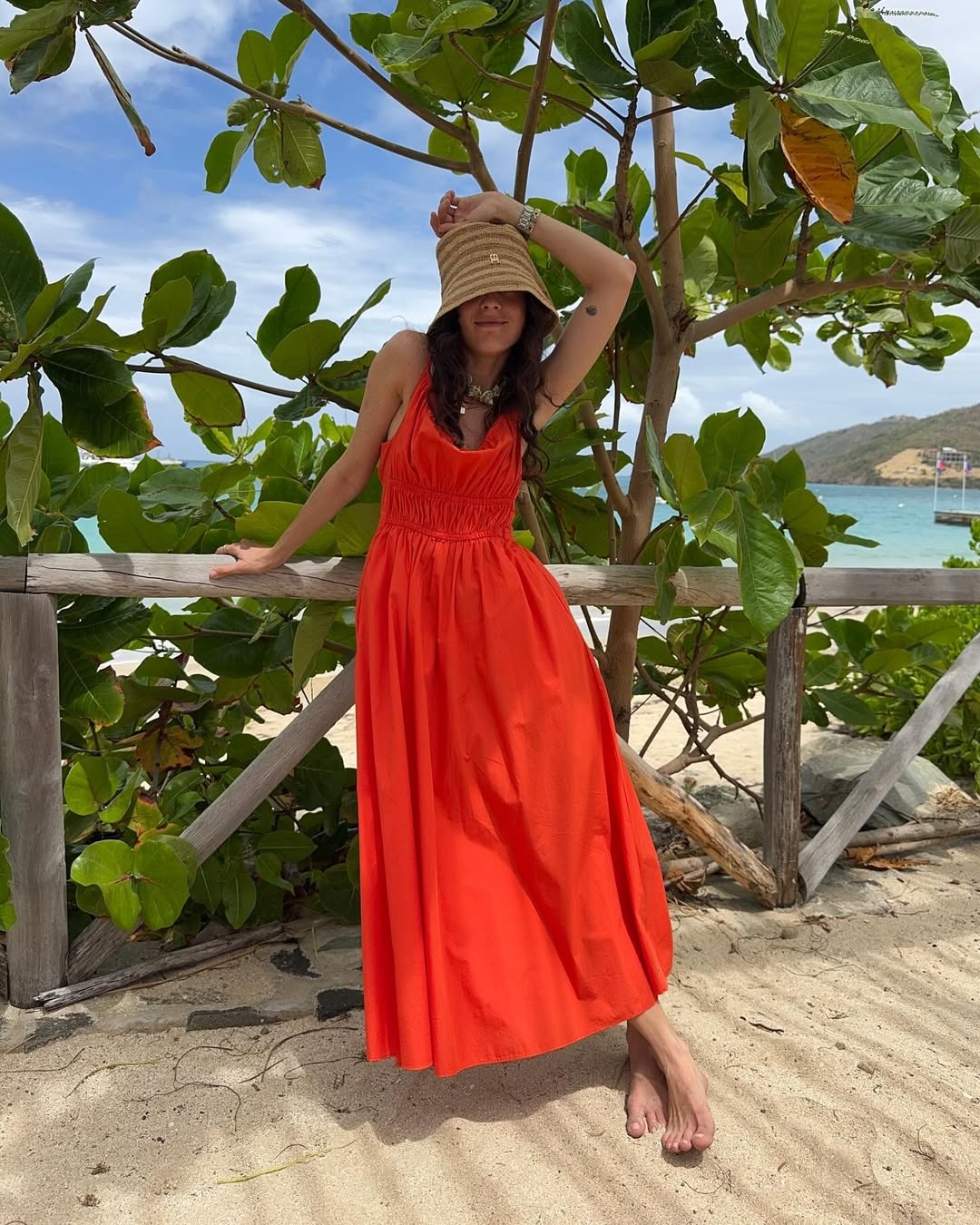 Woman in red dress and straw hat