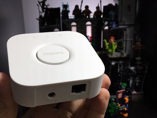 Philips Hue 2nd Generation Bridge being held in a hand