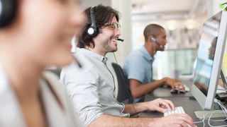 sales support staff on computers talking to customers