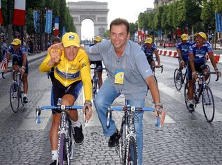 Johan Bruyneel with Lance Armstrong on the Champs Elysees in 2002