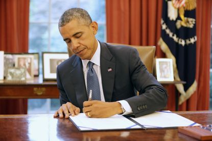 President Obama signs a bill.