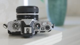 The top of the Nikon Z fc camera on a shelf