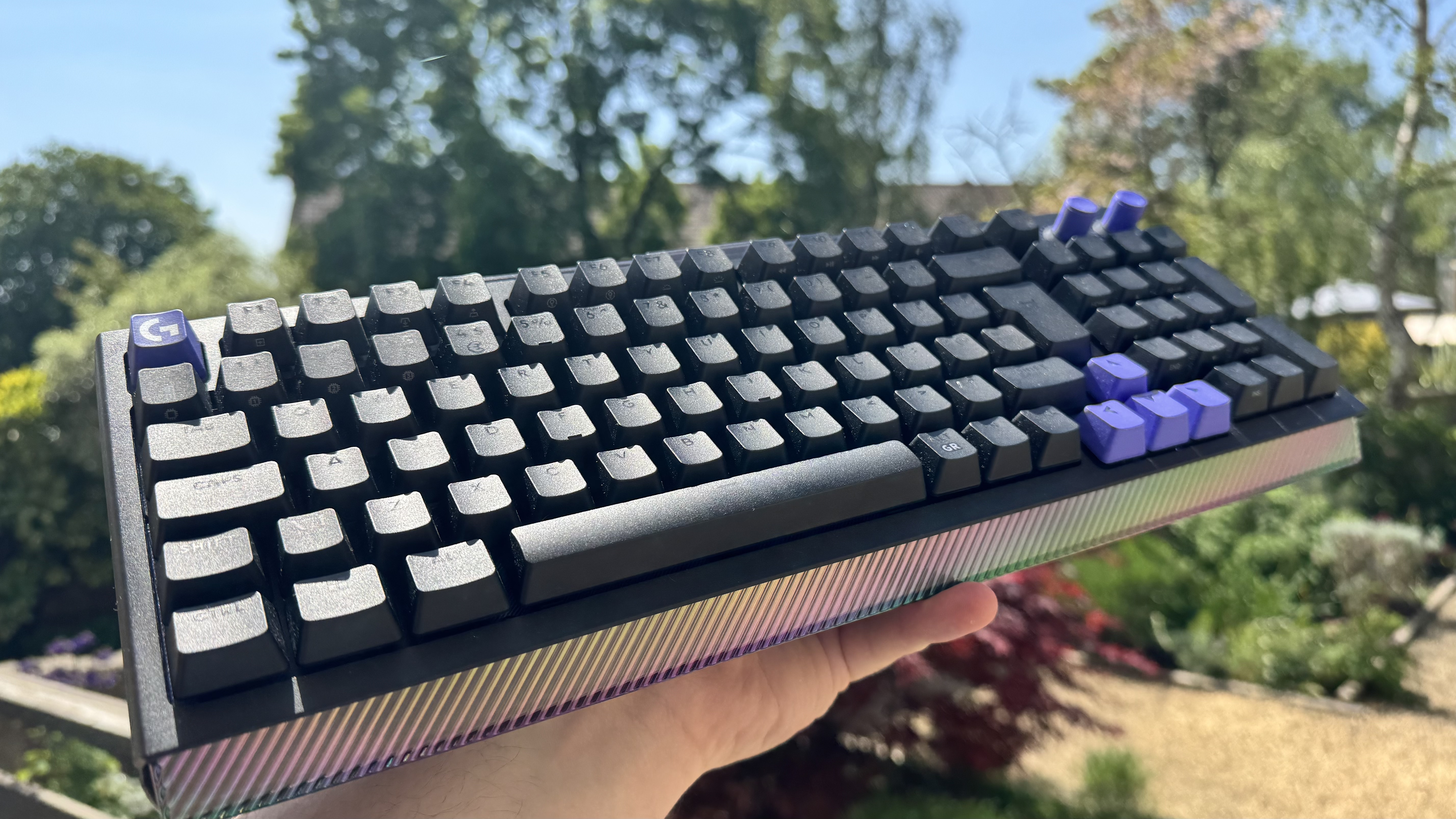 The Logitech G512 X gaming keyboard   from the front left, outside, showing off the light bar