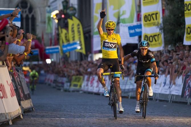 Chris Froome (Sky) salutes as he crosses the finish line alongside teammate Richie Porte