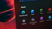 Close-up of Surface Laptop for Business 8th Edition desktop with pinned applications, including Microsoft Edge, Word, Excel, and Microsoft 365 Copilot. 