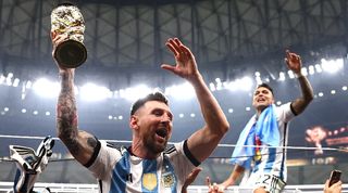 Lionel Messi celebrates with the World Cup trophy after Argentina's win on penalties over France in the 2022 World Cup final at Lusail Stadium in Qatar.