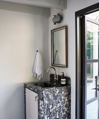 modern bathroom with chrome and gray color scheme and dark marble