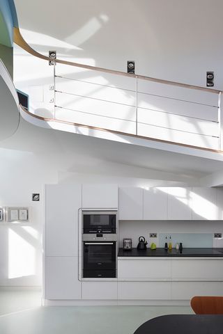 The kitchen and sloping galley leading up to the terrace balcony and the floating conservatory