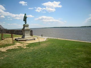 A statue of a man by the water