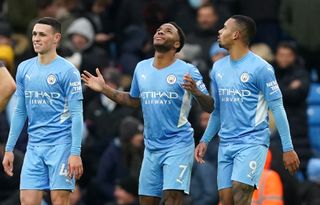 Manchester City’s Raheem Sterling (centre) celebrates scoring their side’s first goal of the game from the penalty spot during the Premier League match at the Etihad Stadium, Manchester. Picture date: Saturday December 11, 2021