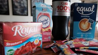 photo of a box of sugar free gelatin, a diet coke, crystal light mix, equal artificial sweetener in a box and a box of trident gum