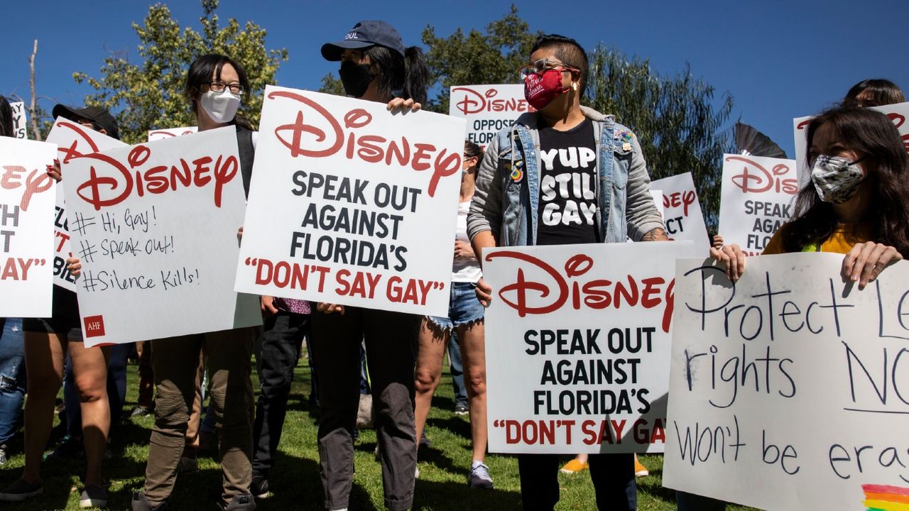 Protesters holding placards reading &amp;#039;Disney - speak out against Don&amp;#039;t Say Gay&amp;#039;