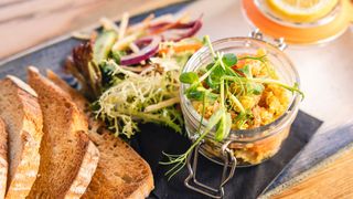 Potted lobster dish with salad and toast
