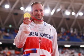 Jason Kenny holding a gold medal