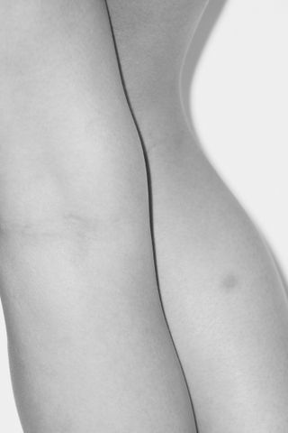 Black and white up close photo of lady's legs