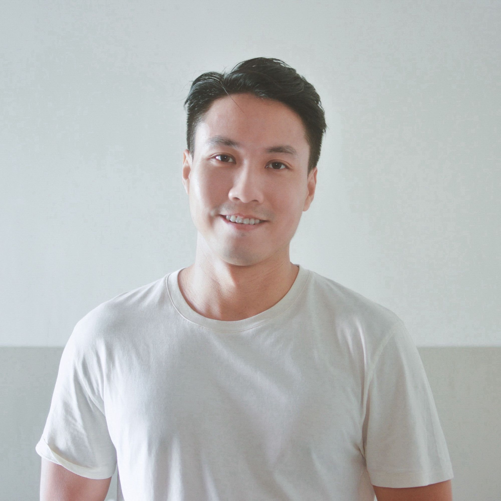Danny Leung is a man with dark black hair and is wearing a white T-shirt