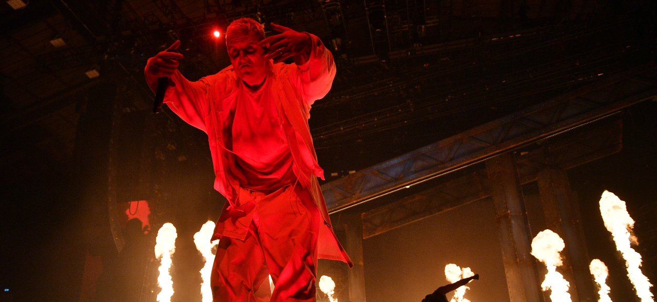 Winston McCall on stage surrounded by fire
