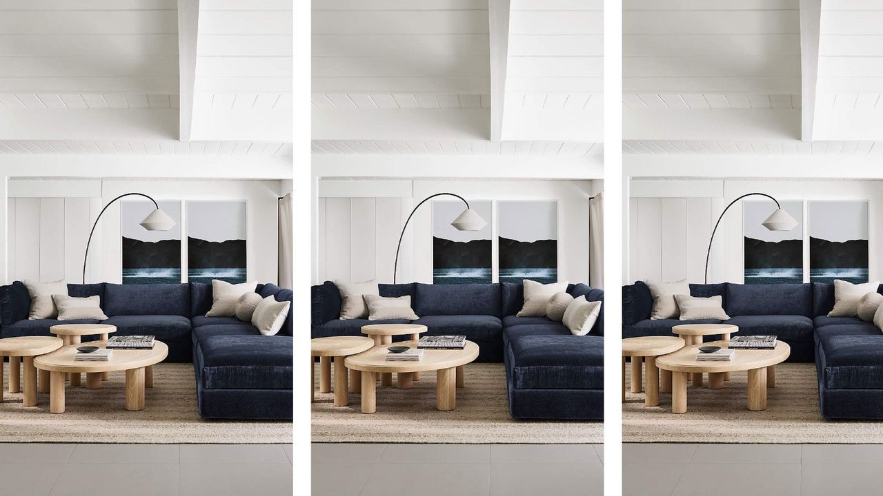 Crate &amp; Barrel coastal home decor living room with a blue couch and a wooden coffee table and seaside photos