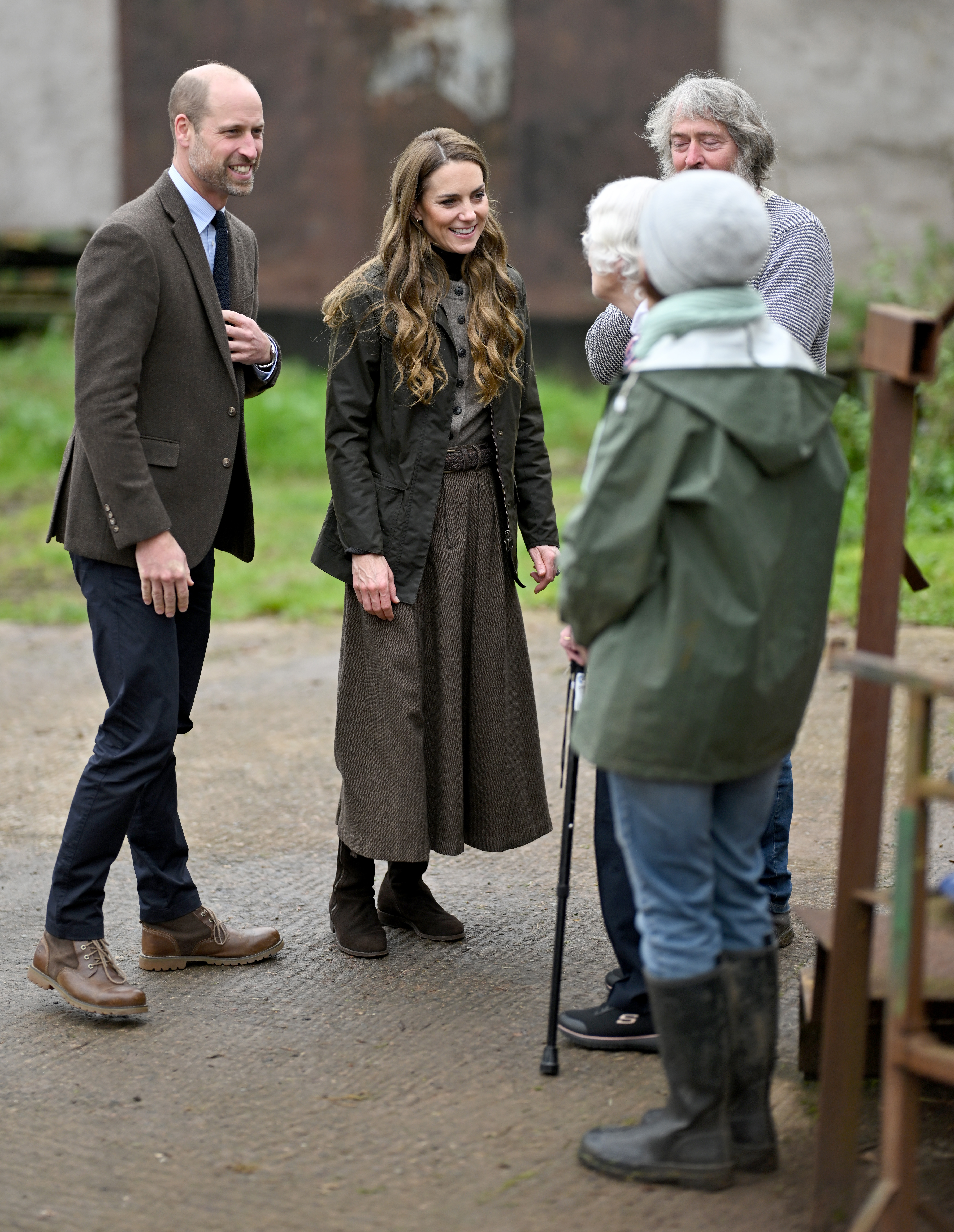 Prince William and Kate Middleton on a farm talking to old women