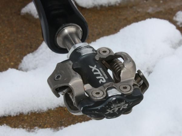 Shimano XTR pedals offer dependable performance with stout bearings proven to hold up well to mud.