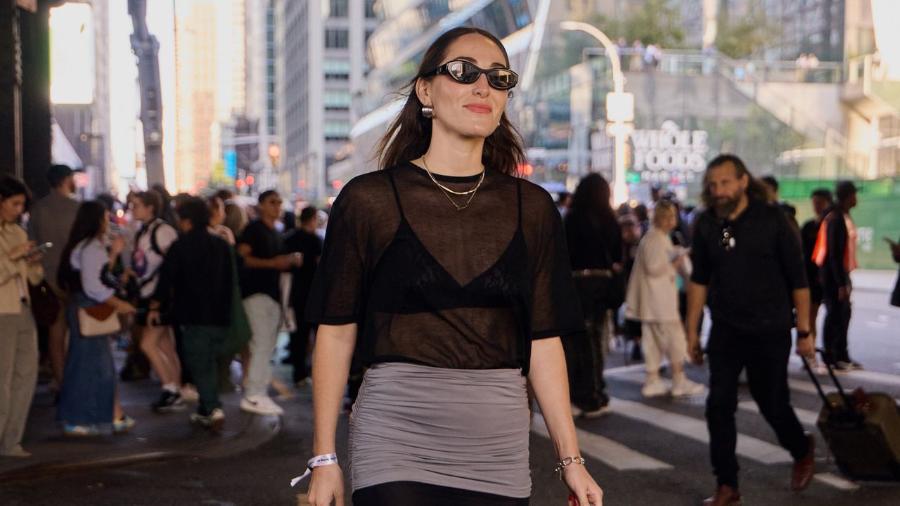 Anna LaPlaca during NYFW wearing a sheer St. Agni top with a Tory Burch skirt.