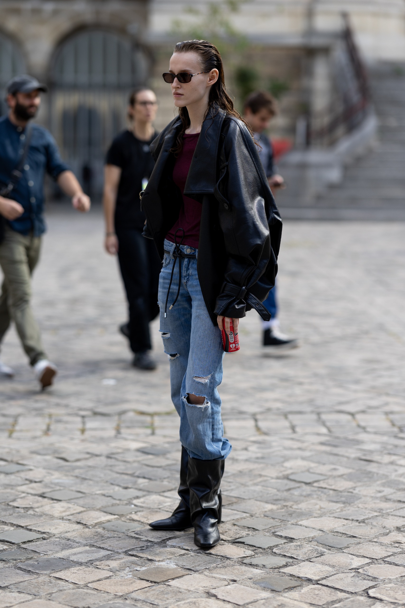 A French girl at Paris Fashion Week wearing a leather jacket and jeans