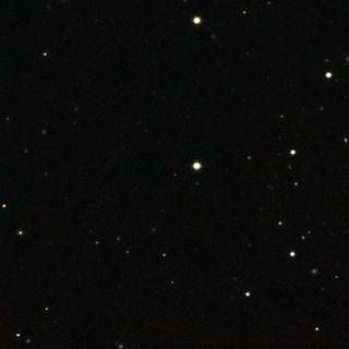 This image of ULAS J1120+0641, a very distant quasar powered by a black hole with a mass 2 billion times that of the sun, was created from images taken from surveys made by both the Sloan Digital Sky Survey and the UKIRT Infrared Deep Sky Survey. The quasar appears as a faint red dot close to the centre.