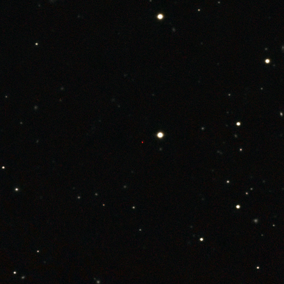 This image of ULAS J1120+0641, a very distant quasar powered by a black hole with a mass 2 billion times that of the sun, was created from images taken from surveys made by both the Sloan Digital Sky Survey and the UKIRT Infrared Deep Sky Survey. The quasar appears as a faint red dot close to the centre.