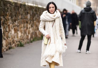 Fashion week attendee wears oversize cashmere scarf