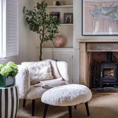 Faux fur chair and foot stool in neutral room