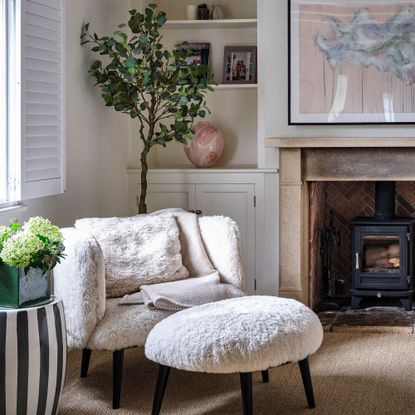 Faux fur chair and foot stool in neutral room