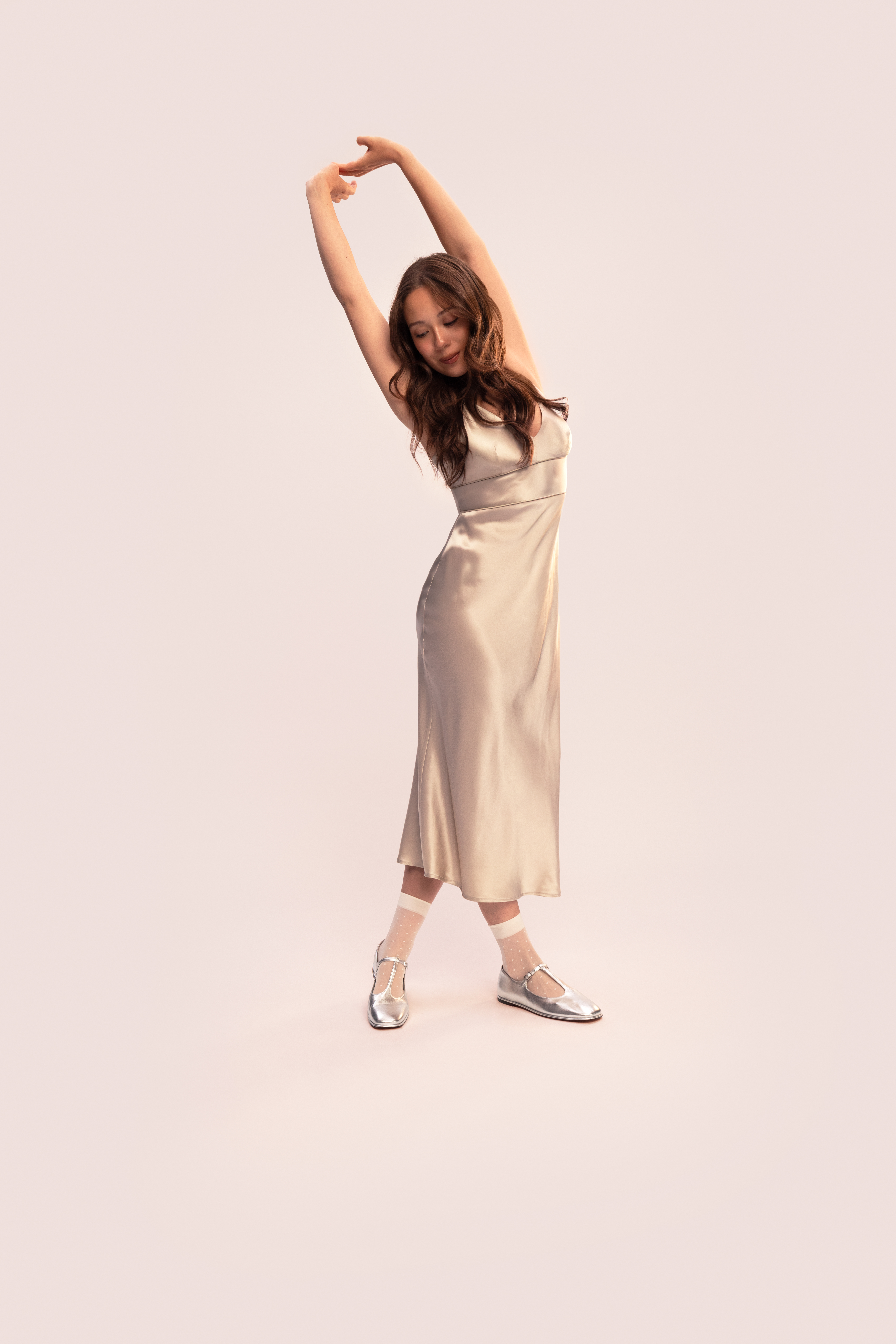 Laufey posing for Everlane&#039;s Fall 2025 Campaign, wearing a dress, sheer socks, and flats