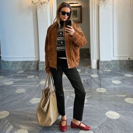 Woman in sweater, suede jacket, and corduroy pants