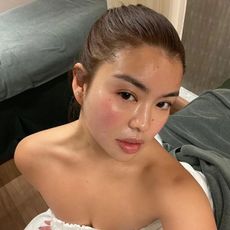 A woman taking a selfie with glowing skin