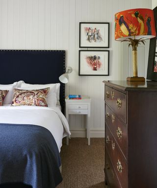 Bedroom carpet ideas with natural fibre carpet, antique dresser and blue upholstered bed