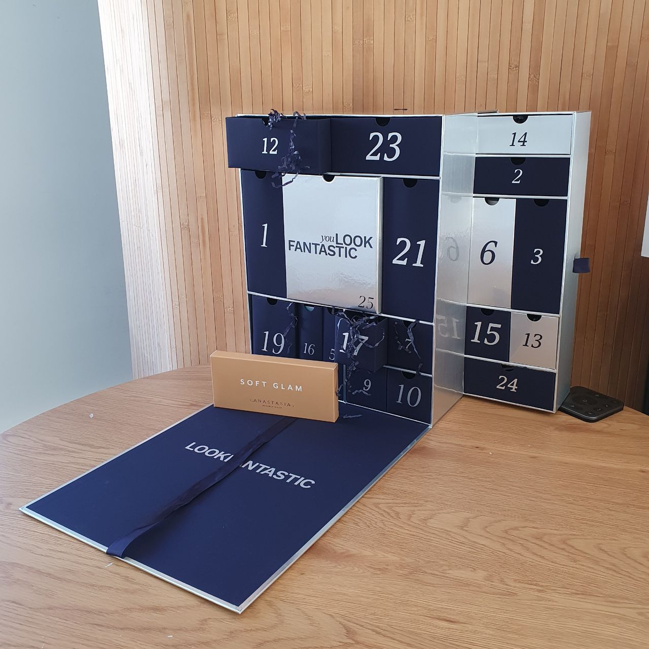 Lookfantastic beauty advent calendar 2024 against a wood-panelled background