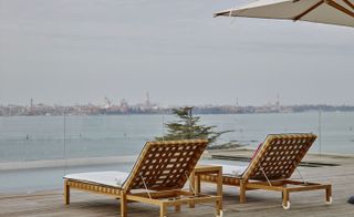 Wooden recliners looking out over view of lake and city