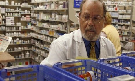 A Florida pharmacist fills prescriptions: Six of the 10 top-selling drugs will go generic in the next two years, which will make them cheaper for patients.