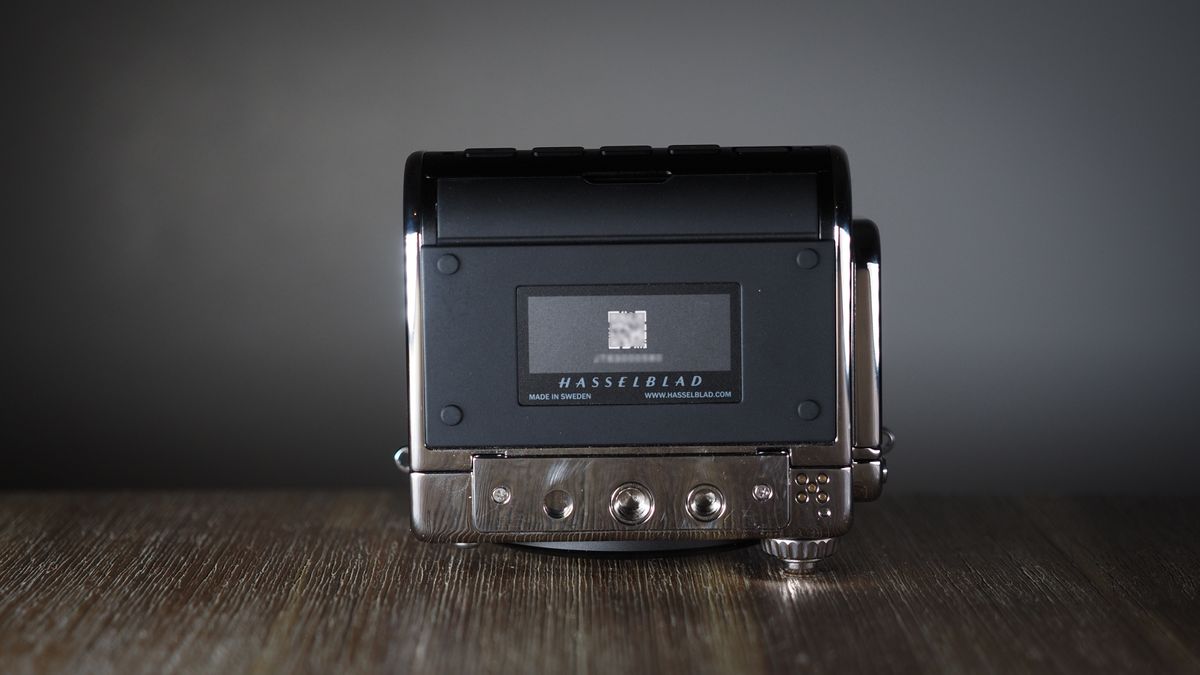 The Hasselblad 907X &amp; CFV 100C medium format camera with digital back, on a wooden table with artistic lighting