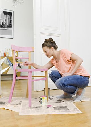 Woman painting a chair