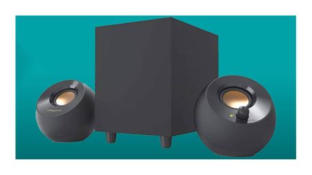 Creative Pebble Plus speakers on a teal deals background