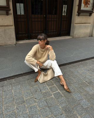 woman in white jeans and beige sweater