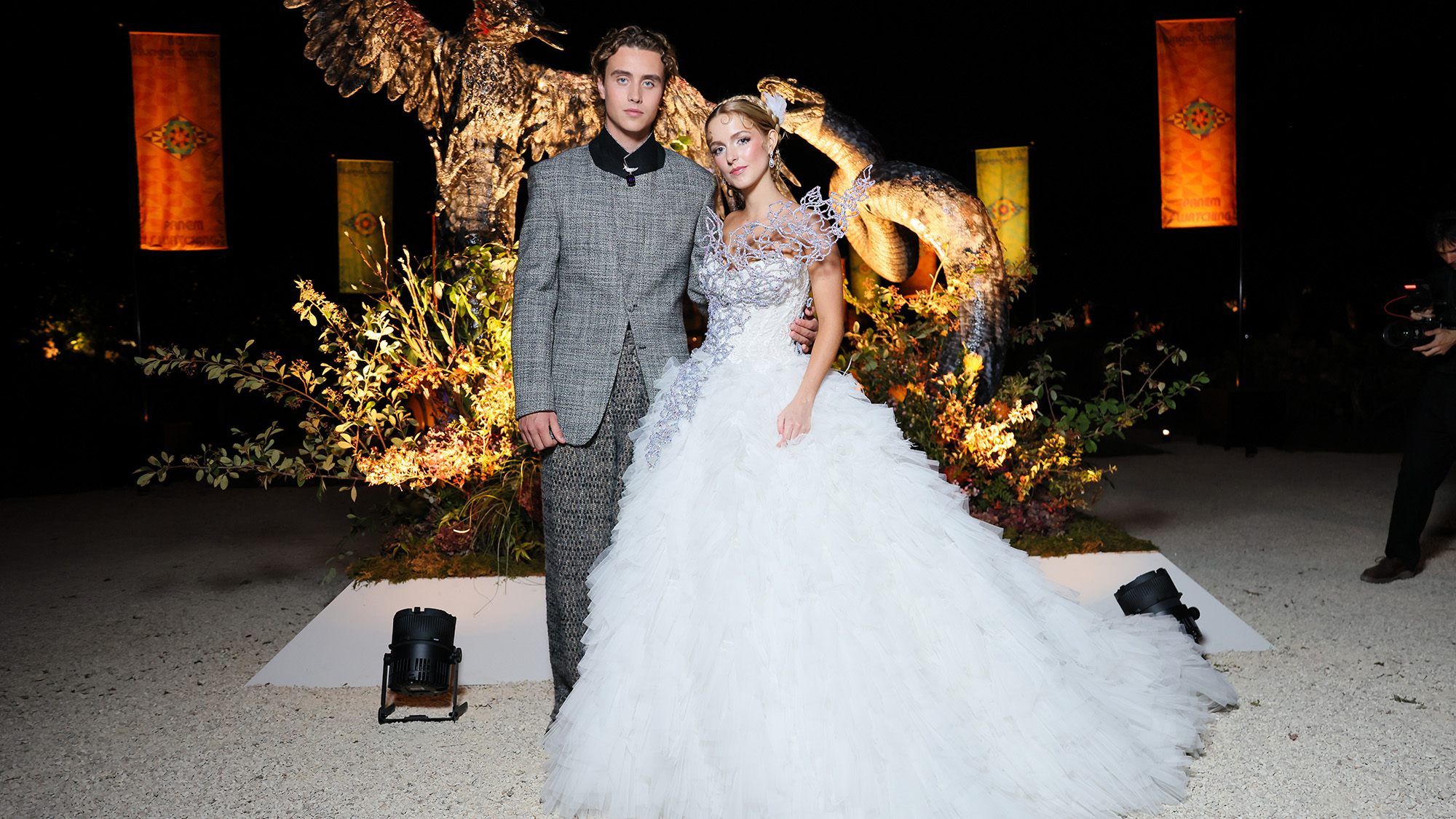 Joseph Zada and McKenna Grace wear a suit and dress perfectly fit for Panem at museum event October 2026.