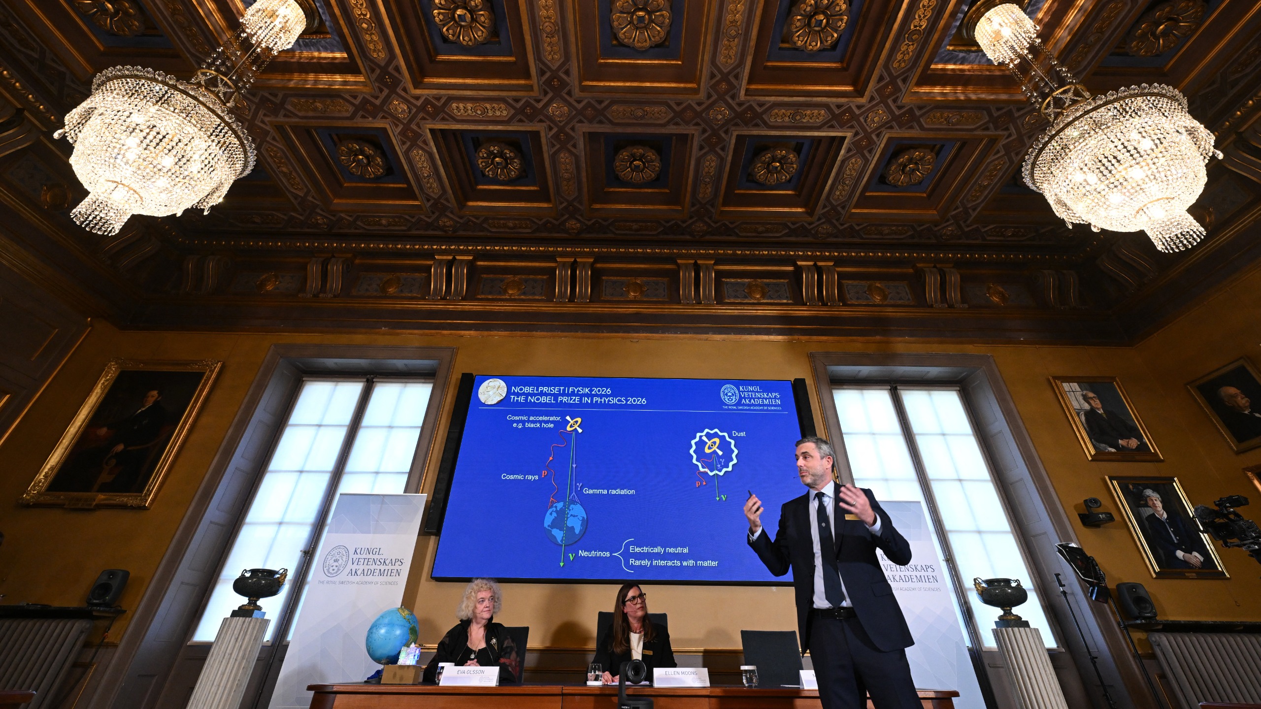 A photo of Mark Pearce, chair of the Nobel Committee for Physics, speaking about Francis Halzen's work during the 2026 Nobel Prize in Physics announcement at the Royal Swedish Academy of Sciences.
