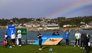 A golfer hits a tee shot on the 7th hole at Pebble Beach Golf Links