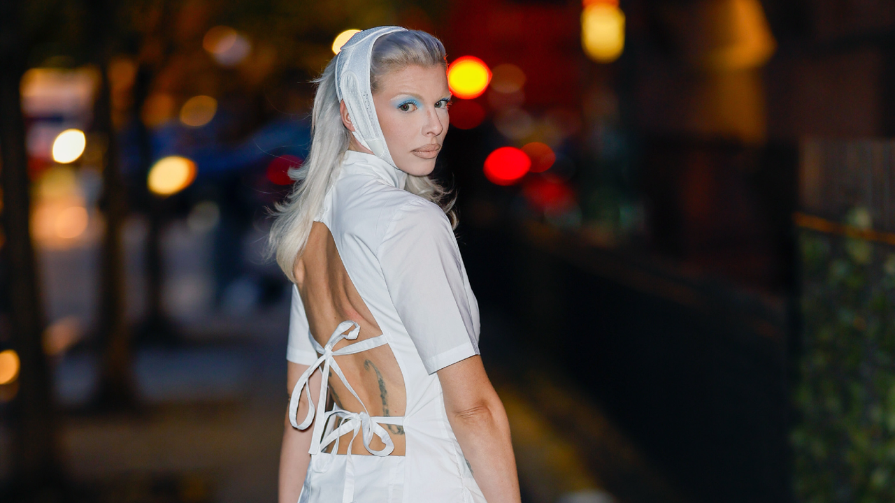 Julia Fox wearing white and posing for a camera